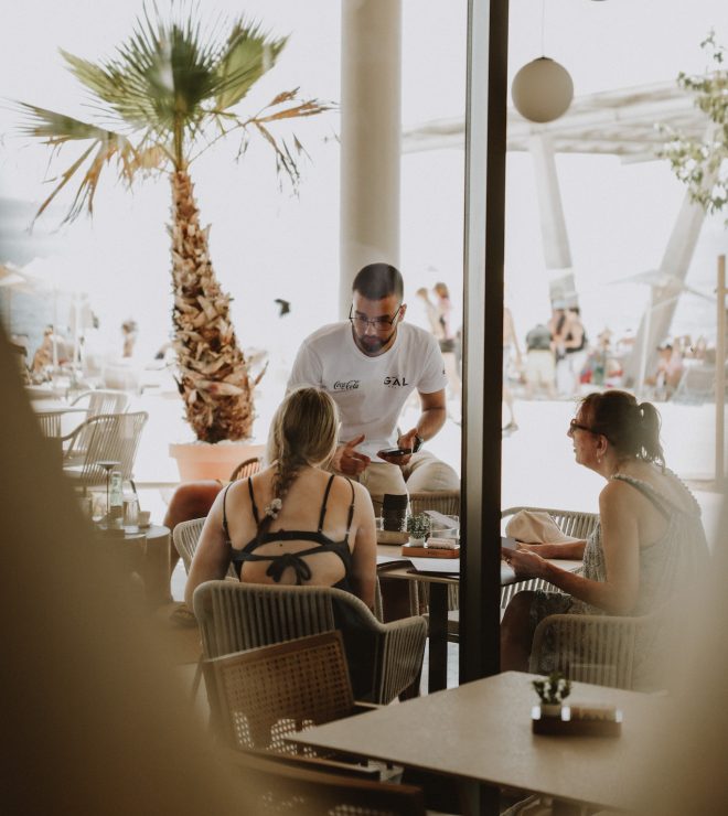 Waiter serving guests at Gal Split beachside café