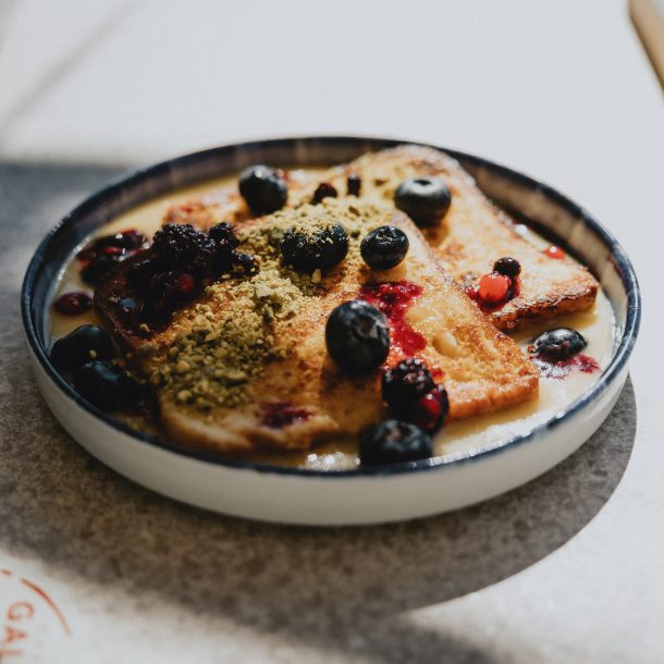 French toast topped with blueberries, pistachio, and berry sauce at GAL Split